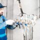 Workman installing water heating system